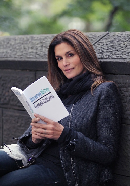 Kenneth Goldsmith: Uncreative Writing: Managing Language in the Digital Age, 2011, READING...Supermodel Cindy Crawford poses with "Uncreative Writing" by Kenneth Goldsmith on a park bench on 5th ave. at Central Park today..Exclusive photo by Lawrence Schwartzwald